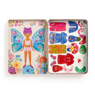 Colorful toy tin with a fairy design and various accessories on a white background