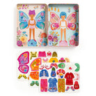 Colorful toy set with fairy-themed tin, figurine, and dress-up clothes on a white background