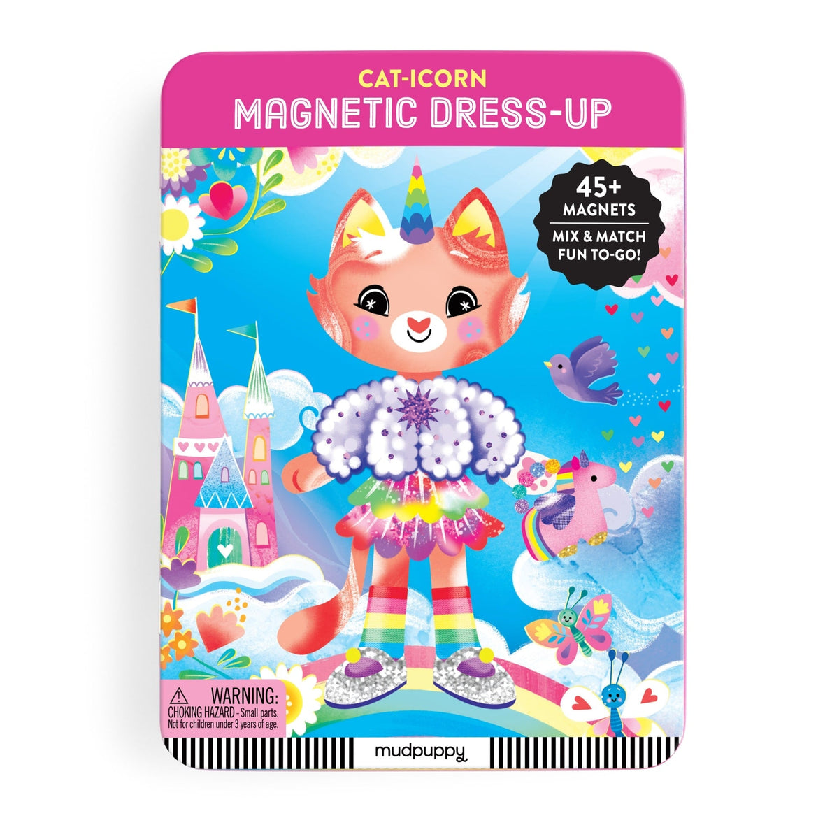 The open Cat-icorn Magnetic Dress-up play set by Mudpuppy displays a pink hinged tin interior featuring a woodland background scene with an illustrated feline character ready for dress-up play. Magnetic pieces and accessories are arranged inside, accompanied by a warning label and barcode at the bottom.