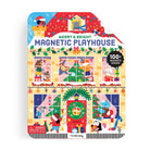 An open interior view of the Merry & Bright Magnetic Playhouse by Mudpuppy tin set, displaying a colorful holiday room scene with a fireplace, Christmas tree, and decorated windows ready for arranging the included magnetic play pieces.
