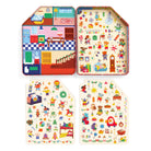 An open interior view of the Merry & Bright Magnetic Playhouse by Mudpuppy tin set showing a colorful holiday room backdrop, accompanied by two sheets displaying dozens of pre-cut holiday-themed magnetic play pieces.
