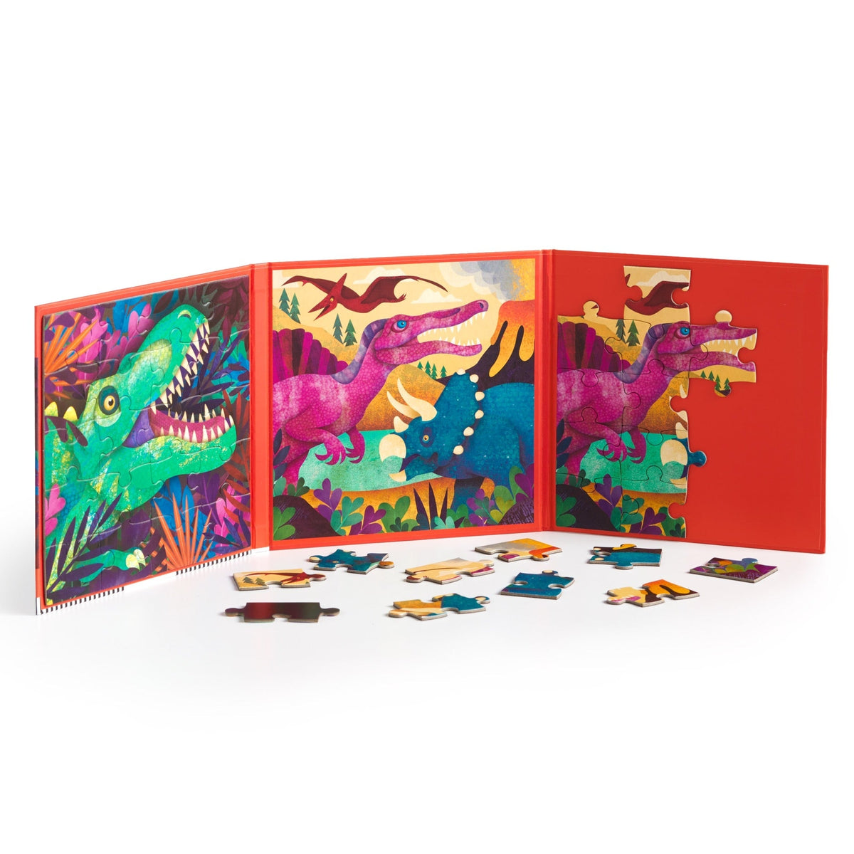 Dinosaurs Roar! Magnetic Puzzle Set open on a red trifold playboard, displaying colorful dinosaur scenes with loose puzzle pieces scattered on the surface below.