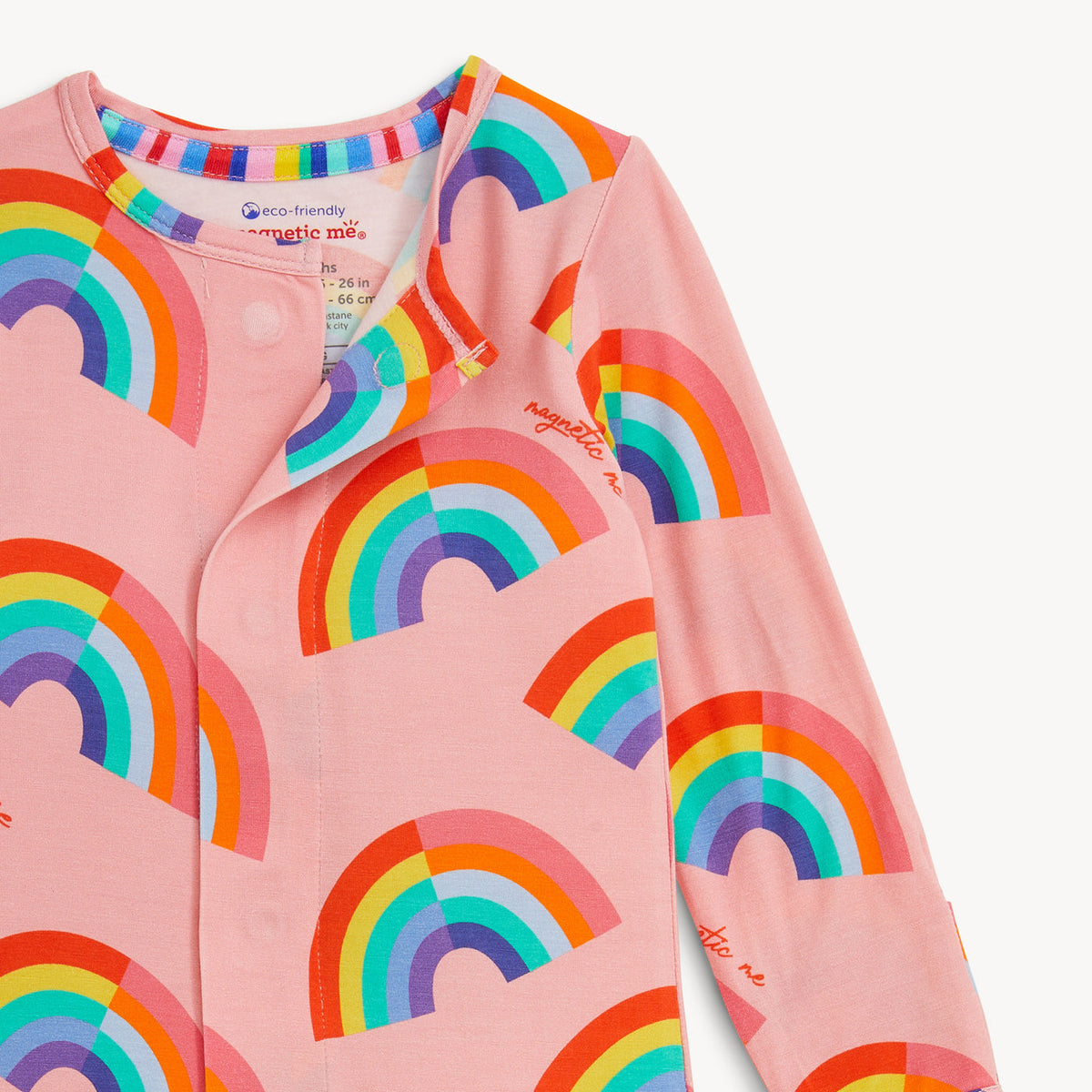 Pink children's shirt with rainbow patterns on a white background