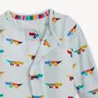 Children's outfit with colorful alligator pattern on a white background