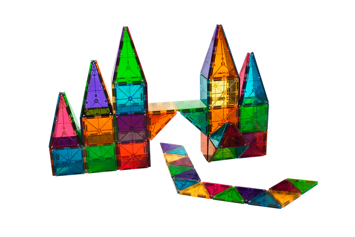 Colorful, translucent magnetic tiles assembled into castle-like structures and a winding path, shown against a transparent background.