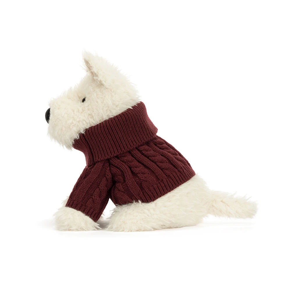 A plush dog toy wearing a burgundy cable-knit turtleneck sweater, photographed on a clean white background.