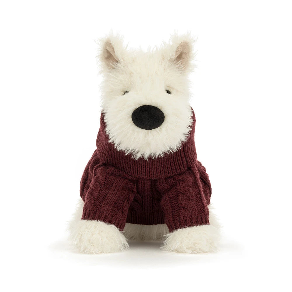 A plush dog toy wearing a burgundy cable-knit sweater, photographed against a seamless white background.