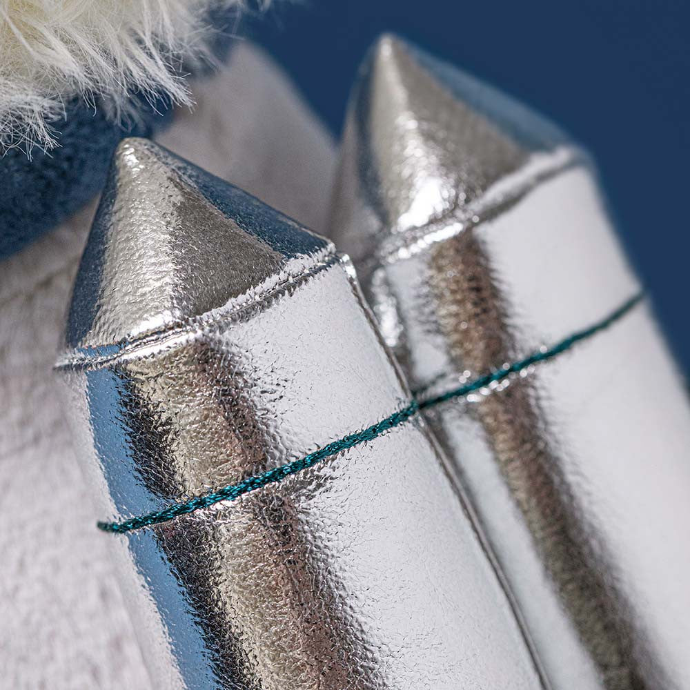 Close-up of metallic lipstick applicators with a blurred background