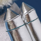 Close-up of metallic lipstick applicators with a blurred background