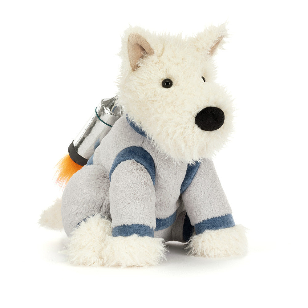 A plush toy dog wearing a gray astronaut suit with blue stripes and a small silver space backpack with an orange flame detail, photographed on a clean white background.