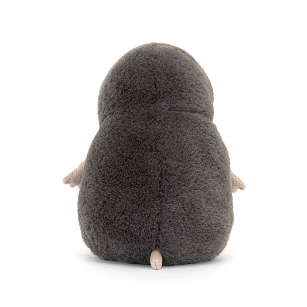 Plush toy penguin from behind on a white background