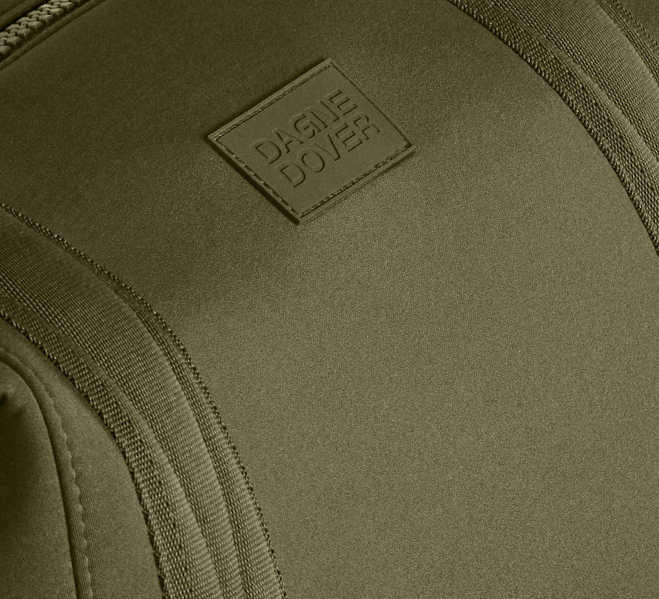 Close-up of a green bag with a brand logo on a matching background
