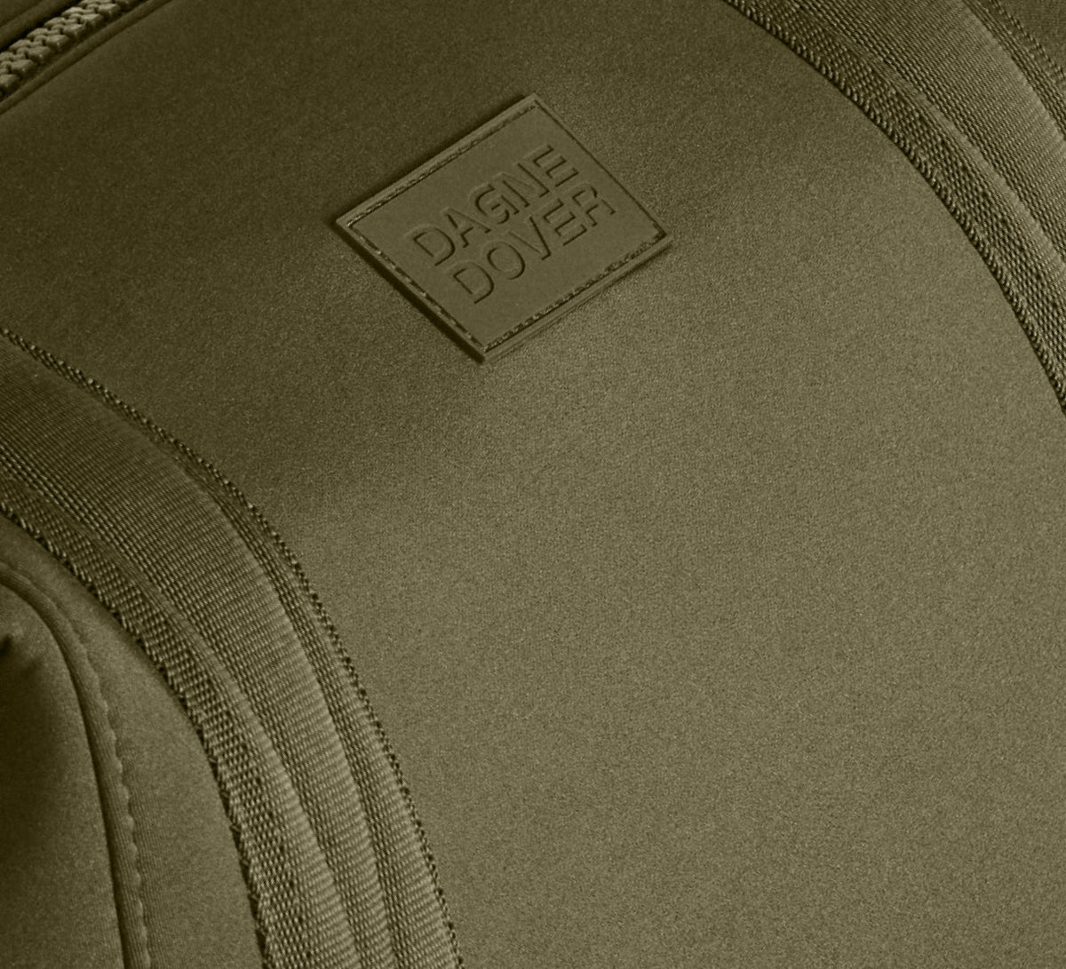 Close-up of a green bag with a brand logo on a matching background