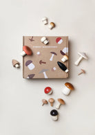Wooden Mushroom Play Set. The set features assorted mushroom-shaped pieces in natural wood tones and playful colors on a grey background.