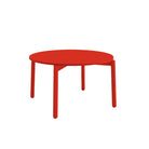 A minimalist red round table with four legs, shown on a solid white background.