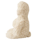 White sheepskin dog-shaped cushion on a white background