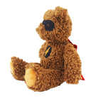 A brown curly-haired teddy bear plush toy wearing a black superhero mask and cape with a yellow emblem on the chest, sitting against a plain white background.