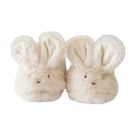 Pair of cream-colored bunny slippers on a white background