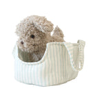 Striped pet carrier with a fluffy toy inside on a white background