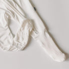 White baby socks with sole pattern on a light gray background
