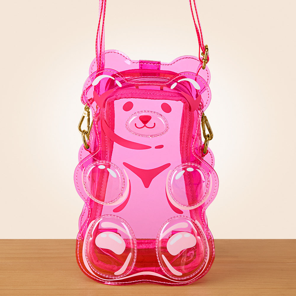 Pink transparent bear-shaped bag on a wooden surface with a beige background