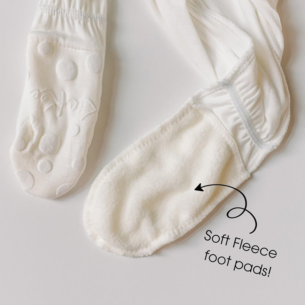 White socks with soft fleece foot pads on a light gray background