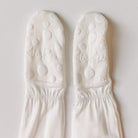 Pair of white socks with bubble pattern and 'kie kee' branding on a light gray background