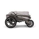 A folded stroller in a light gray heathered fabric with a dark gray frame and black wheels, shown from a side profile on a white background.