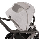 Gray baby seat on a stroller with a white background