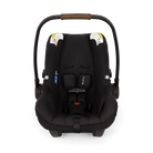 A front view of a black MIXX Next + Pipa Aire RX Travel System by Nuna infant car seat featuring a brown leatherette carry handle and safety harness straps with magnetic buckle holders, set against a checkered transparent background.