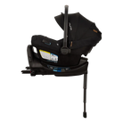 A profile view of a black MIXX Next + Pipa Aire RX Travel System by Nuna infant car seat attached to its base with a load leg, featuring an extended canopy, set against a checkered transparent background.