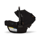 A profile view of a black MIXX Next + Pipa Aire RX Travel System by Nuna infant car seat featuring an exposed aerospace aluminum handle and an extended canopy, set against a checkered transparent background.