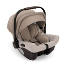Beige baby car seat with black straps on a white background
