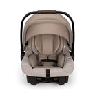 Beige baby car seat with black straps on a white background