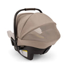 Beige baby car seat with canopy on a white background
