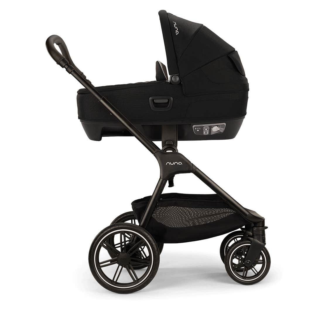 Nuna stroller and bassinet combo in black, featuring a black bassinet attached to a black stroller frame with a handlebar and mesh storage basket, shown on a white background.