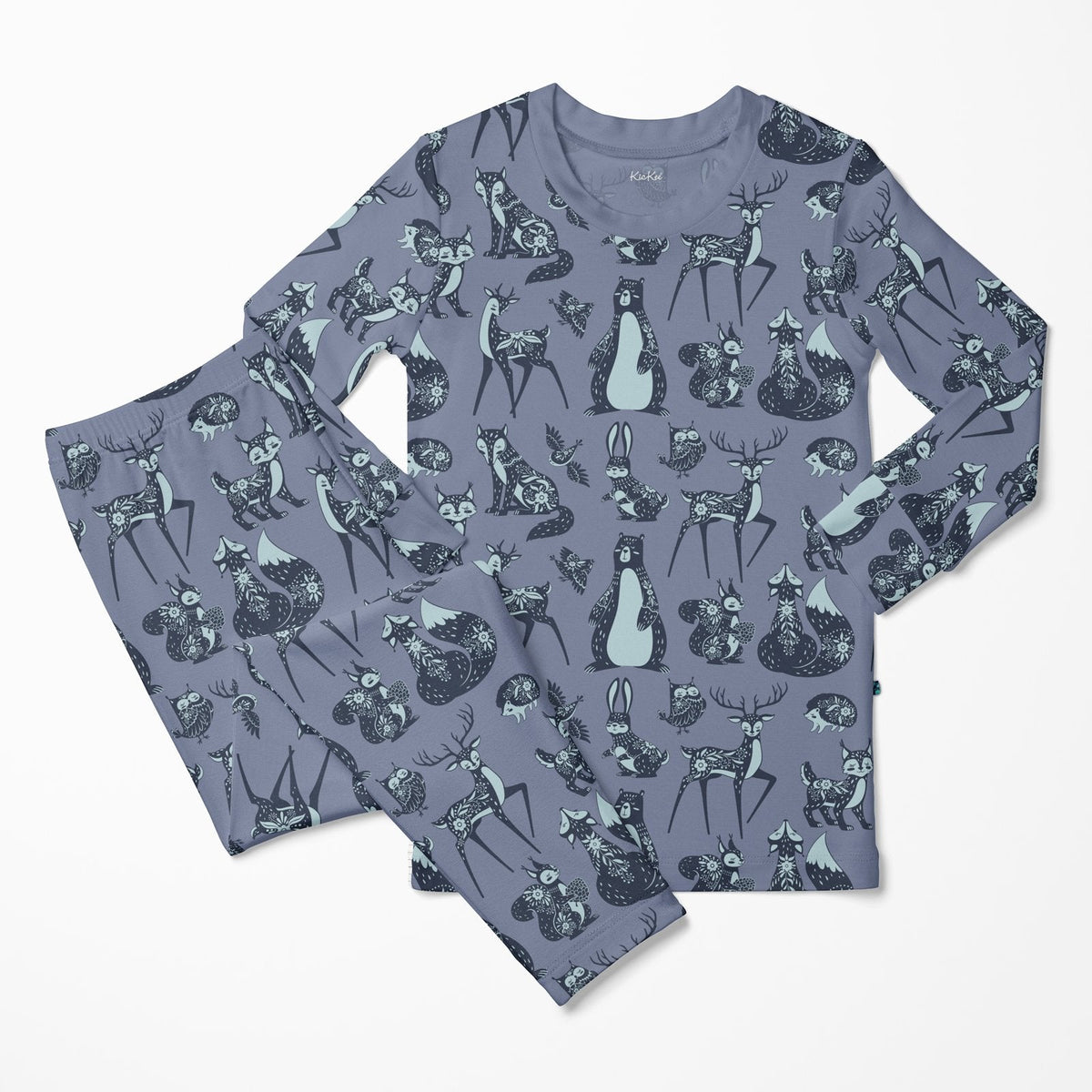 A two-piece pajama set featuring a long-sleeve top and matching pants in a dusty slate blue-gray color, decorated with an all-over pattern of woodland animals including deer, rabbits, foxes, and a penguin in dark navy and light blue-gray.