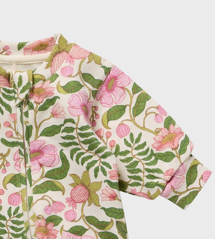 Floral patterned fabric with pink flowers and green leaves on a white background