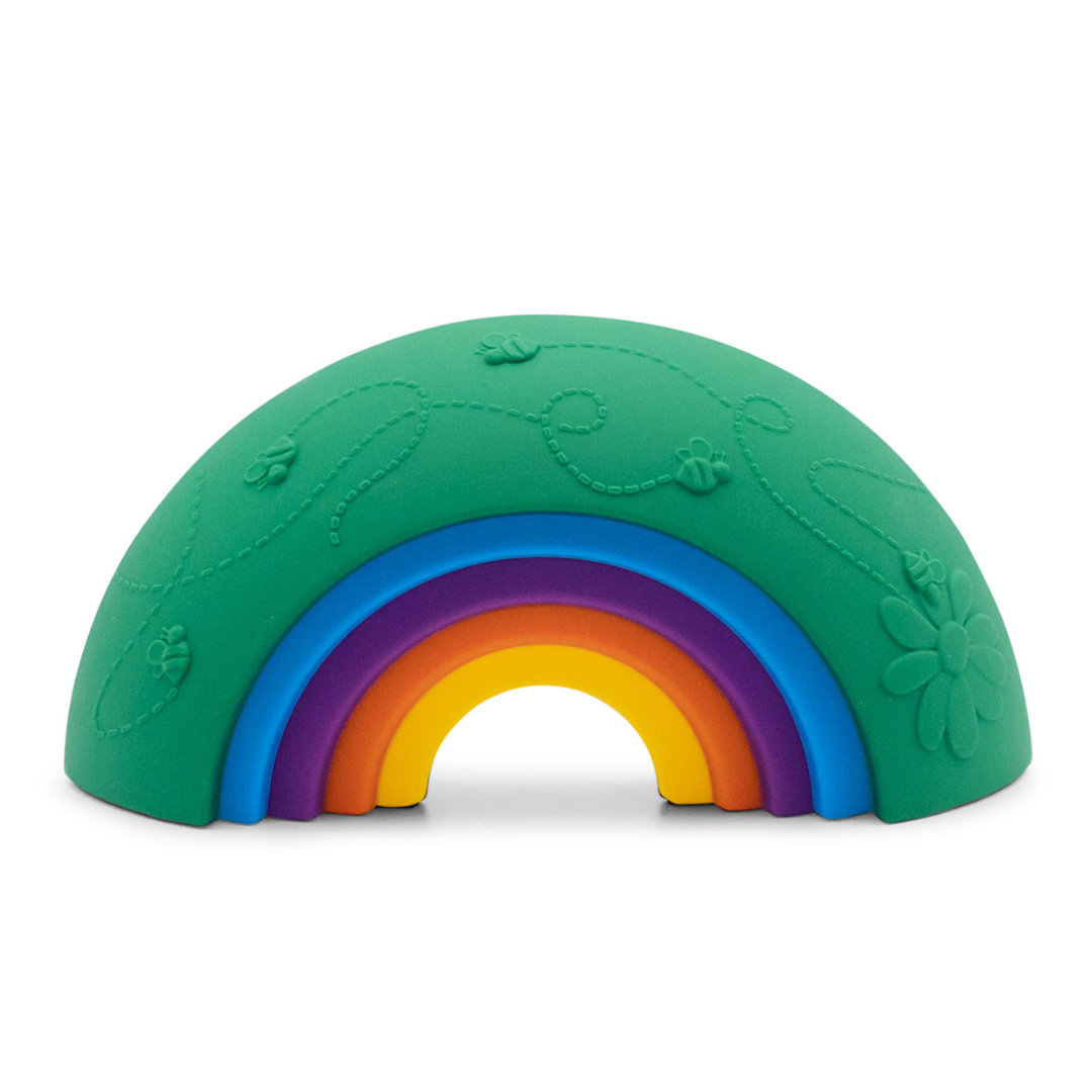 A green silicone arch-shaped toy with a raised rainbow design in the center, featuring embossed floral and leaf patterns on the top half, shown on a white background.