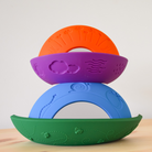 Stack of colorful silicone rings on a light background