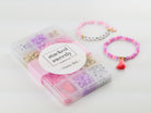Princess Party DIY Bracelet Kit featuring a compartment storage box with a "stacked sweetly - Princess Party" label, filled with colorful beads, alphabet letter beads, and charms next to two completed pink, purple, and gold beaded bracelets, including one spelling "PRINCESS" with a small crown and tassel charm.