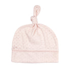 Pink baby hat with a knot on top against a white background