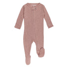 Pink baby onesie with a button on a white background