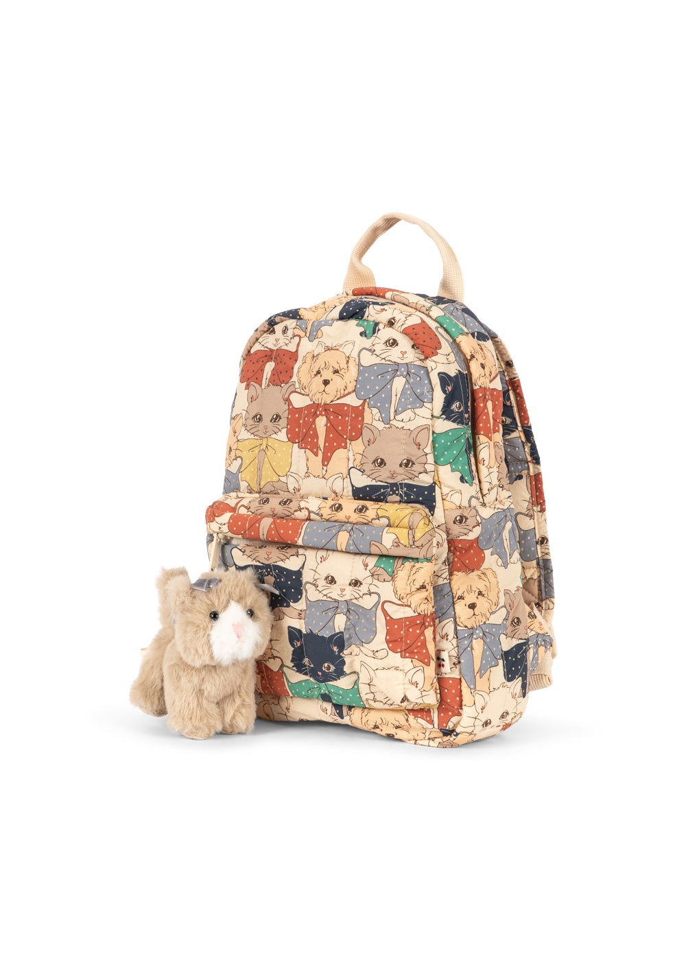 A small canvas backpack with an all-over print of illustrated cats in colorful outfits, shown on a plain white background with plush toy kitten.
