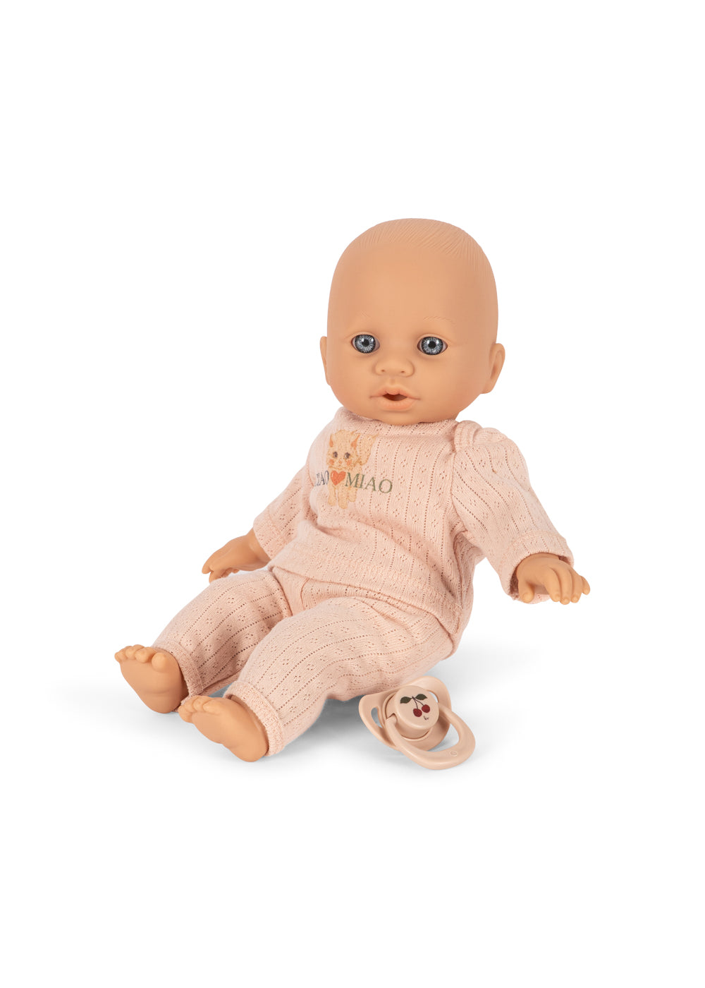 A baby doll wearing a pale pink ribbed onesie with a dog print, on a plain white background.
