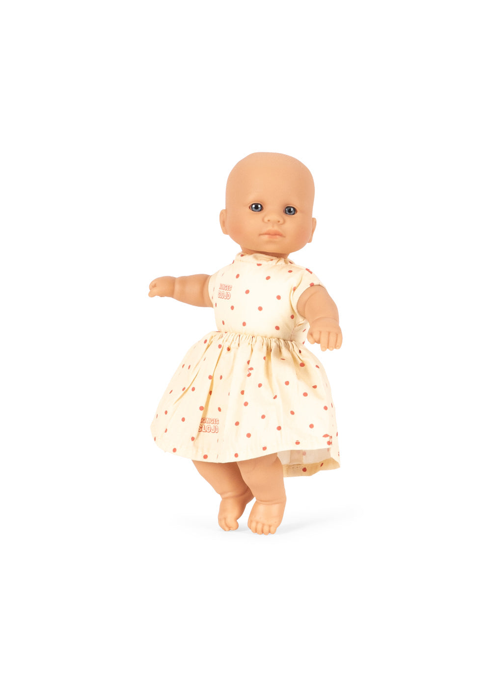 Baby doll wearing a white dress with red patterns on a white background