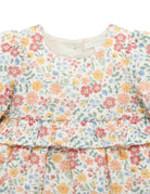 Floral dress with a ruffled neckline on a white background