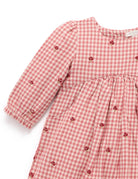 Red and white checkered dress with buttons on a white background