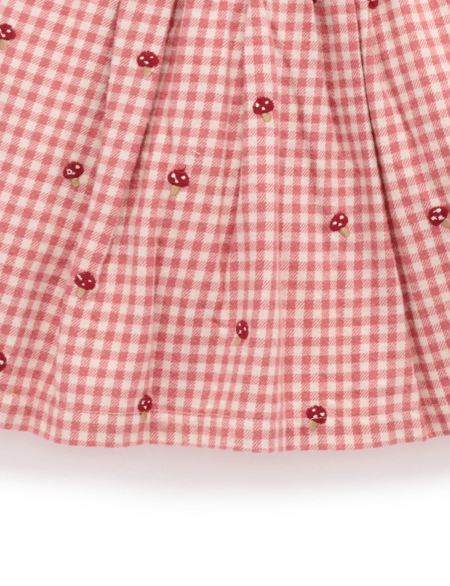 Red and white checkered fabric with small red flower patterns on a white background
