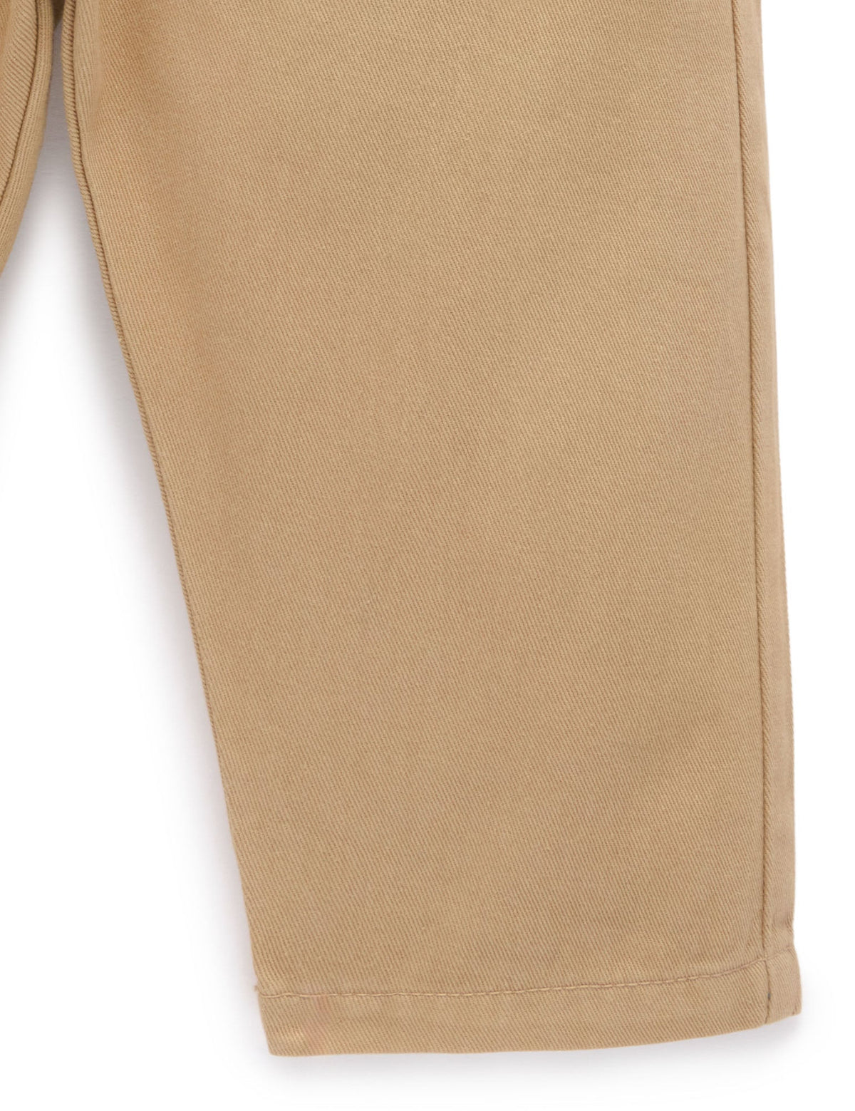 Close-up of beige pants on a white background